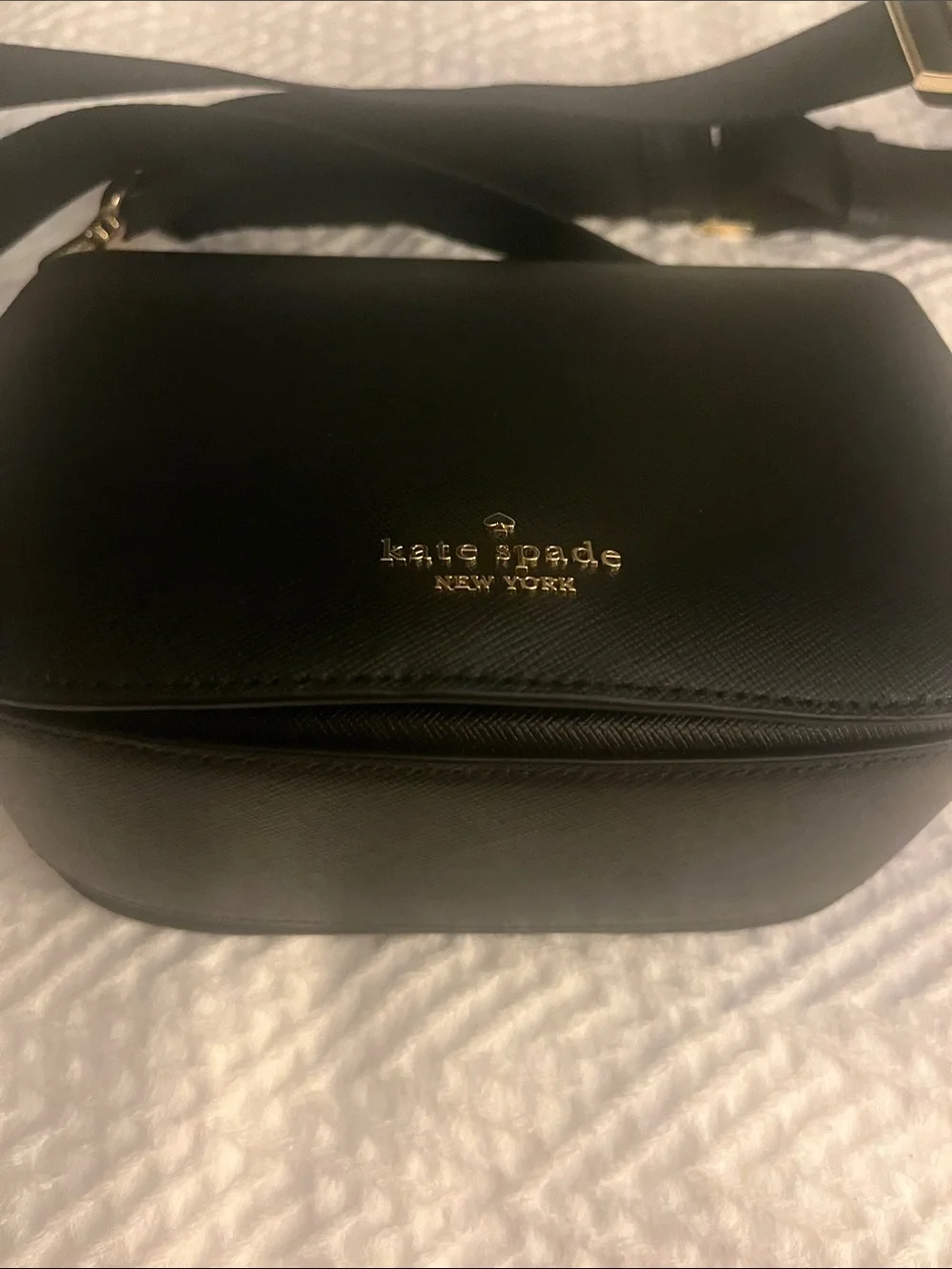 Kate Spade black crossbody saddlebag with gold logo